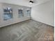 Spacious bedroom featuring three windows providing lots of natural light and neutral carpeting at 120 Cadbury Ln, Fort Mill, SC 29715