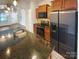 Kitchen with granite countertops, stainless steel appliances, and dark wood cabinets at 120 Cadbury Ln, Fort Mill, SC 29715