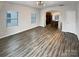 Bright living room featuring wood-look floors, contemporary lighting, and direct access to the kitchen island at 120 Cadbury Ln, Fort Mill, SC 29715
