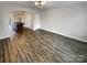 Open-concept living room with modern lighting, wood-look flooring, and an arched doorway to the kitchen at 120 Cadbury Ln, Fort Mill, SC 29715