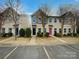 Attractive townhouses featuring manicured lawns, a parking lot, and unique door colors at 120 Cadbury Ln, Fort Mill, SC 29715