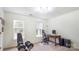 Bedroom with natural light, desk, and workout equipment at 12011 Olden Ct, Charlotte, NC 28262