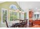 Inviting breakfast area with large windows, a stylish chandelier, and a view of the surrounding greenery at 12011 Olden Ct, Charlotte, NC 28262