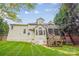 Backyard exterior featuring a large deck, screened porch and backyard at 12011 Olden Ct, Charlotte, NC 28262
