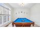 Entertaining game room featuring a pool table, a window for natural light, and neutral decor for versatile use at 12011 Olden Ct, Charlotte, NC 28262