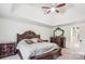 Relaxing main bedroom featuring a tray ceiling, plush carpet, and elegant furniture for a comfortable retreat at 12011 Olden Ct, Charlotte, NC 28262