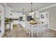 Bright kitchen with white cabinetry, stainless steel appliances, and a functional center island at 12541 Willingdon Rd, Huntersville, NC 28078