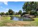 Beautiful community entrance with waterfall feature and pond surrounded by lush greenery at 12541 Willingdon Rd, Huntersville, NC 28078