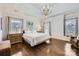 Bright main bedroom with hardwood floors, large windows, and elegant furnishings at 131 Sardis Pointe Rd, Matthews, NC 28105