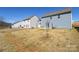 View of the home's expansive backyard with a view of neighboring houses and trees in the distance at 133 Batten Ridge Dr, Statesville, NC 28677