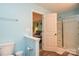 Bathroom featuring a doorway view to the bedroom, a shower, and light blue walls at 133 Batten Ridge Dr, Statesville, NC 28677