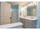 Bright bathroom featuring double sinks, shower, and a framed mirror, designed with a cohesive style at 133 Batten Ridge Dr, Statesville, NC 28677