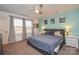 Comfortable bedroom with a ceiling fan, carpeted floors, and abundant natural light from a window at 133 Batten Ridge Dr, Statesville, NC 28677