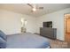 Bedroom with a ceiling fan, carpeted floors, a grey dresser, and a view into the ensuite bathroom at 133 Batten Ridge Dr, Statesville, NC 28677