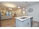 Open-concept kitchen with island seating and stainless steel appliances, seamlessly connected to the living room at 133 Batten Ridge Dr, Statesville, NC 28677
