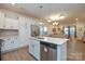 Bright, modern kitchen featuring an island, stainless steel appliances, and an open layout to the living area at 133 Batten Ridge Dr, Statesville, NC 28677