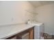 Clean, organized laundry room with shelving, washer, dryer, and countertop space at 133 Batten Ridge Dr, Statesville, NC 28677