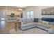Open-concept living room featuring hardwood floors, a sectional sofa, and views of the kitchen at 133 Batten Ridge Dr, Statesville, NC 28677