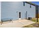 Back of the house with a walk out door, small patio and view of the siding and air conditioning unit at 133 Batten Ridge Dr, Statesville, NC 28677