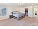 Bright bedroom featuring a walk-in closet and a large window at 1444 Harleston St, Indian Trail, NC 28079
