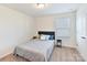 Cozy bedroom featuring neutral walls, carpeted floors, and a comfortable bed with decorative pillows at 1444 Harleston St, Indian Trail, NC 28079