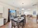 Open dining area with wood floors, flowing to the living room and kitchen with access to outdoor living at 1444 Harleston St, Indian Trail, NC 28079