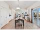 Bright kitchen and dining area featuring white cabinetry and stainless steel appliances at 1444 Harleston St, Indian Trail, NC 28079