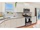 Modern kitchen featuring white cabinetry, stainless steel appliances, and granite countertops at 1444 Harleston St, Indian Trail, NC 28079
