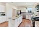 Bright kitchen with stainless steel appliances, granite island, and wood-look flooring at 1444 Harleston St, Indian Trail, NC 28079