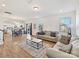 Bright, open-concept living area features hardwood floors, neutral paint, and seamlessly connects to the kitchen and dining area at 1444 Harleston St, Indian Trail, NC 28079