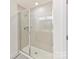 Glass enclosed shower with tiled walls at 1444 Harleston St, Indian Trail, NC 28079