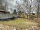 Scenic view of the backyard featuring a deck with a pergola, set against a backdrop of lush trees at 14621 Sapphire Ln, Pineville, NC 28134
