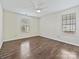 Bedroom with hardwood floors, a ceiling fan, and natural light from two windows at 14621 Sapphire Ln, Pineville, NC 28134