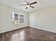 Bedroom with hardwood floors, a ceiling fan, and natural light from a window at 14621 Sapphire Ln, Pineville, NC 28134