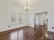 Spacious dining area featuring hardwood floors, natural light, and a stylish chandelier at 14621 Sapphire Ln, Pineville, NC 28134