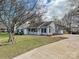 Charming single-story home with a well-manicured front yard, showcasing its inviting curb appeal at 14621 Sapphire Ln, Pineville, NC 28134