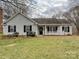 Charming home featuring a manicured front lawn and classic curb appeal with black shutters on the windows at 14621 Sapphire Ln, Pineville, NC 28134
