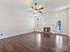Living room features a fireplace, hardwood floors, a ceiling fan, and a patio access door at 14621 Sapphire Ln, Pineville, NC 28134
