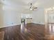 Open-concept living room with hardwood floors and open access to the kitchen and the main entrance at 14621 Sapphire Ln, Pineville, NC 28134