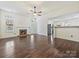 Bright living room with a fireplace, a ceiling fan, and hardwood floors next to a kitchen counter at 14621 Sapphire Ln, Pineville, NC 28134