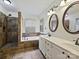 Well-lit main bathroom featuring a shower, a tub, double vanity sinks, and tile floors at 14621 Sapphire Ln, Pineville, NC 28134