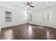 Main bedroom with a ceiling fan, hardwood floors, two windows, and access to the main entrance at 14621 Sapphire Ln, Pineville, NC 28134