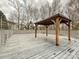 A wooden pergola stands on a backyard deck, providing shade and charm to the outdoor space at 14621 Sapphire Ln, Pineville, NC 28134