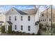 Bright exterior of a two story home with white siding, black roof, and well-maintained landscaping at 1503 Briar Creek Rd # Apt B, Charlotte, NC 28205