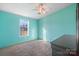 This bedroom has light blue walls, a ceiling fan, a window, and neutral carpet flooring at 166 Sonja Dr, Statesville, NC 28677