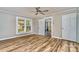 Cozy bedroom with wood-look flooring, a ceiling fan, and plenty of natural light from the large windows at 1759 Smith Ave, Gastonia, NC 28052