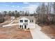 Aerial view of a two-story home on a spacious lot with a long driveway and wooded surroundings at 2032 Country Pl, Hickory, NC 28601
