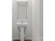 Modern bathroom with a pedestal sink, a framed mirror, and tiled walls with neutral paint at 2032 Country Pl, Hickory, NC 28601
