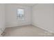 Bedroom featuring carpeted flooring, a window with natural light, and convenient electrical outlets at 2032 Country Pl, Hickory, NC 28601