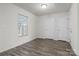 A bedroom featuring wood-look flooring, neutral paint, and a window with blinds at 2032 Country Pl, Hickory, NC 28601